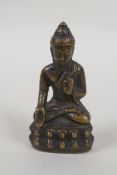 A Tibetan bronze figure of Buddha, 7cm high