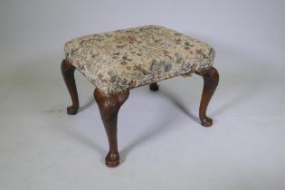 A Georgian walnut footstool on carved cabriole legs, 58 x 67cm