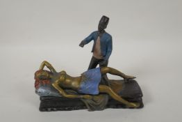 In the manner of Bergmann, a cold painted bronze figure of a Moor and a female nude, 20cm long