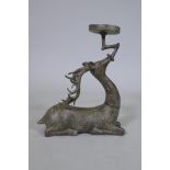 An Eastern patinated bronze censer in the form of a deer, 33cm high