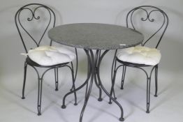 A granite top garden table and two chairs, 75cm diameter