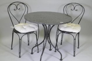 A granite top garden table and two chairs, 75cm diameter