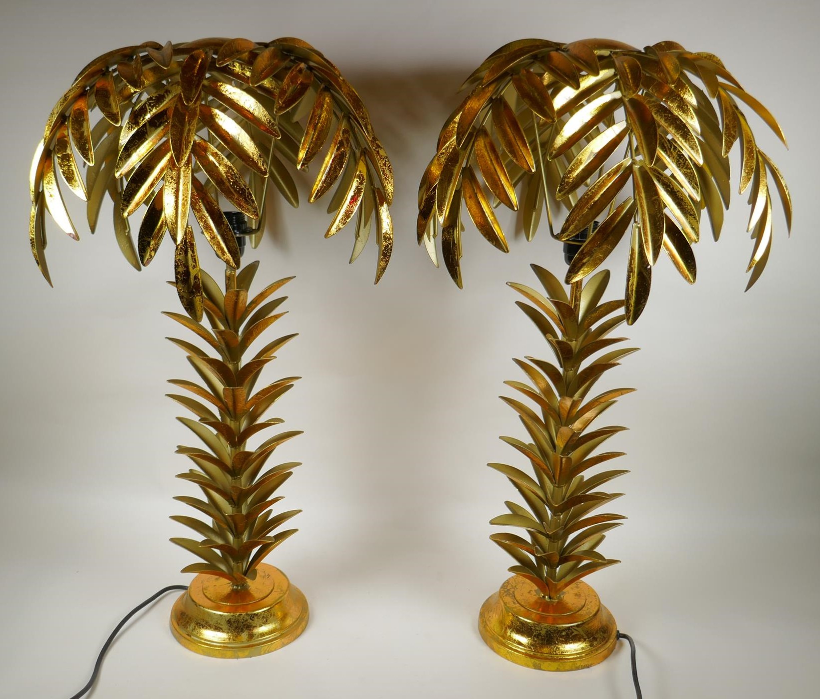 A pair of gilt metal table lamps in the form of palm trees, 71cm high