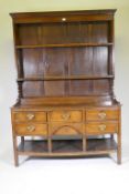 A good C18th Welsh oak dresser, the enclosed delf rack on a base of five drawers, t