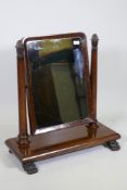 A C19th mahogany swing toilet mirror with tapering supports and original silvered glass, raised on