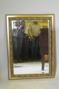 A contemporary gilt wall mirror with moulded decoration, 103 x 76cm