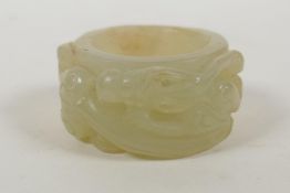 A Chinese hardstone thumb ring with carved dragon decoration