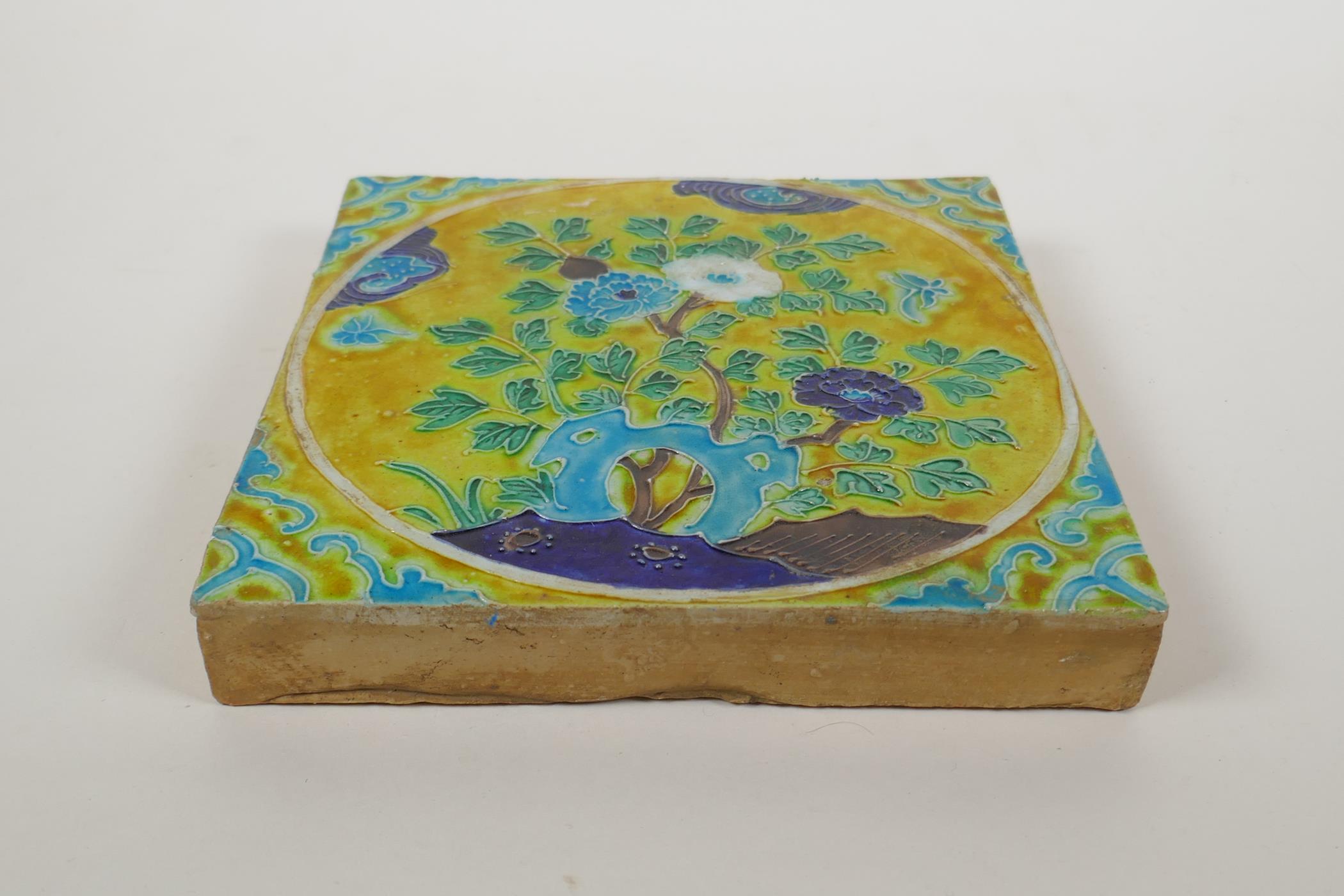 A Chinese yellow ground porcelain temple tile with fahua decoration of flowers, 20 x 20cm - Image 2 of 2