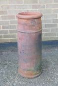 A terracotta chimney pot, 75cm high, 29cm diameter