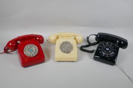 Two vintage rotary dial telephones in red and cream, and a  push button telephone