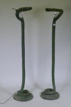 A pair of patinated bronze floor lamps in the form of serpents, 143cm high