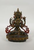 A Tibetan bronze figure of the Buddhist deity Chenrezig, with gilt and painted details, 21cm high