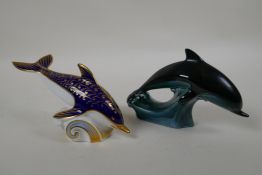 A Royal Crown Derby porcelain dolphin paperweight, together with a Poole Pottery dolphin, largest