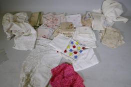 A quantity of antique and vintage linen and lace, Greek table cloth, embroidered napkins, a pink