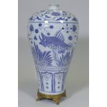 A Chinese ming style blue and white baluster shaped vase decorated with carp amongst reeds and