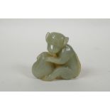 A Chinese carved nephrite jade monkey with a peach, 5cm high