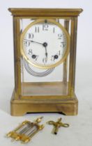 A C19th/C20th brass four glass mantel clock, the porcelain dial with Arabic numerals, inscribed