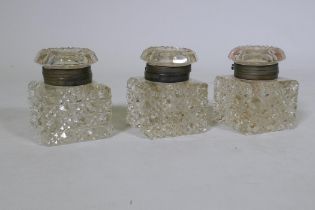 A set of three large Victorian cut glass inkwells with brass mounts, 11cm high