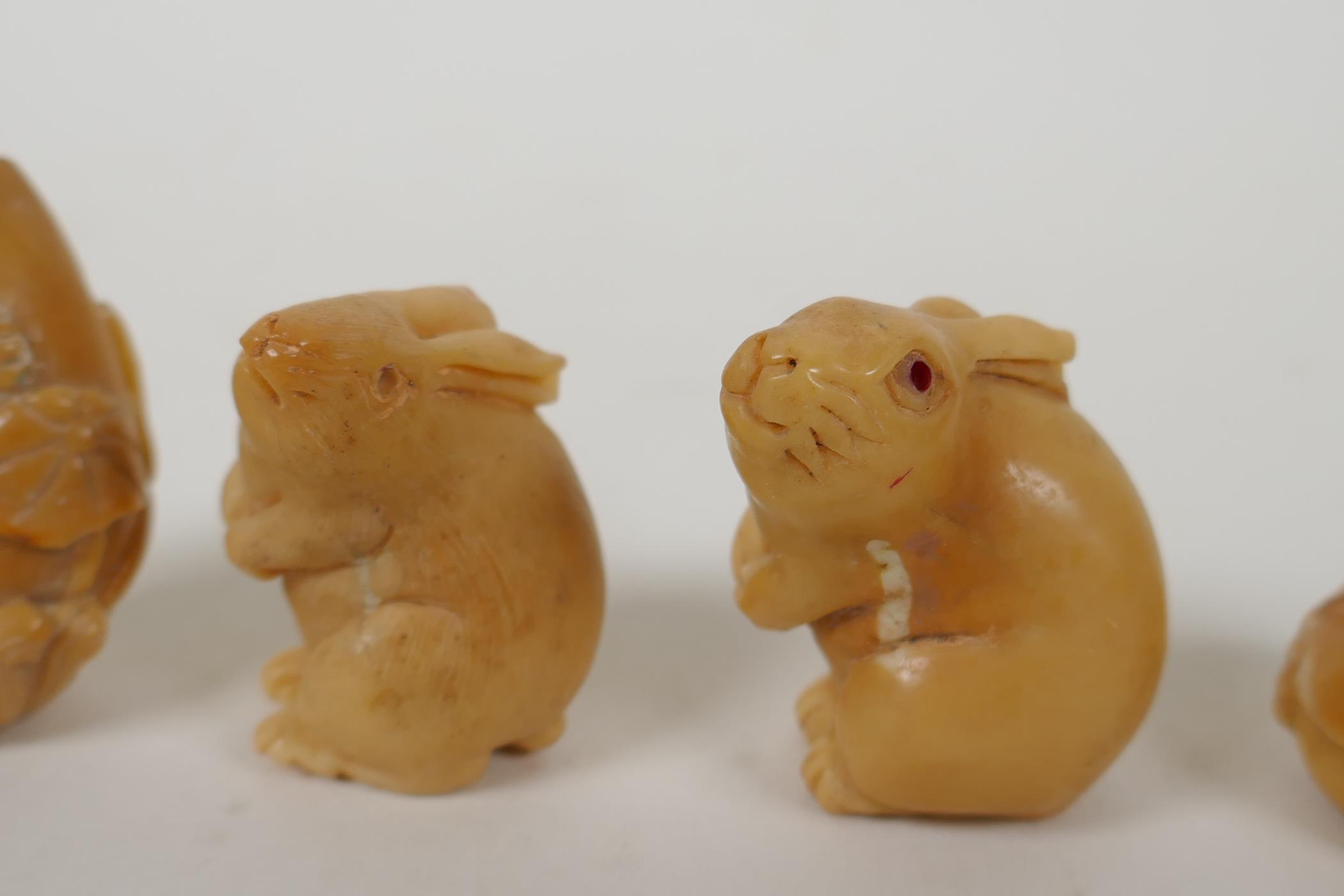 Five Japanese carved tagua nut netsuke in the form of rabbits, mice, lotus flowers and a snake, - Image 4 of 5