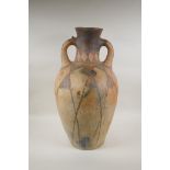 An antique North African terracotta amphora with two handles and hand painted design, AF, 63cm high
