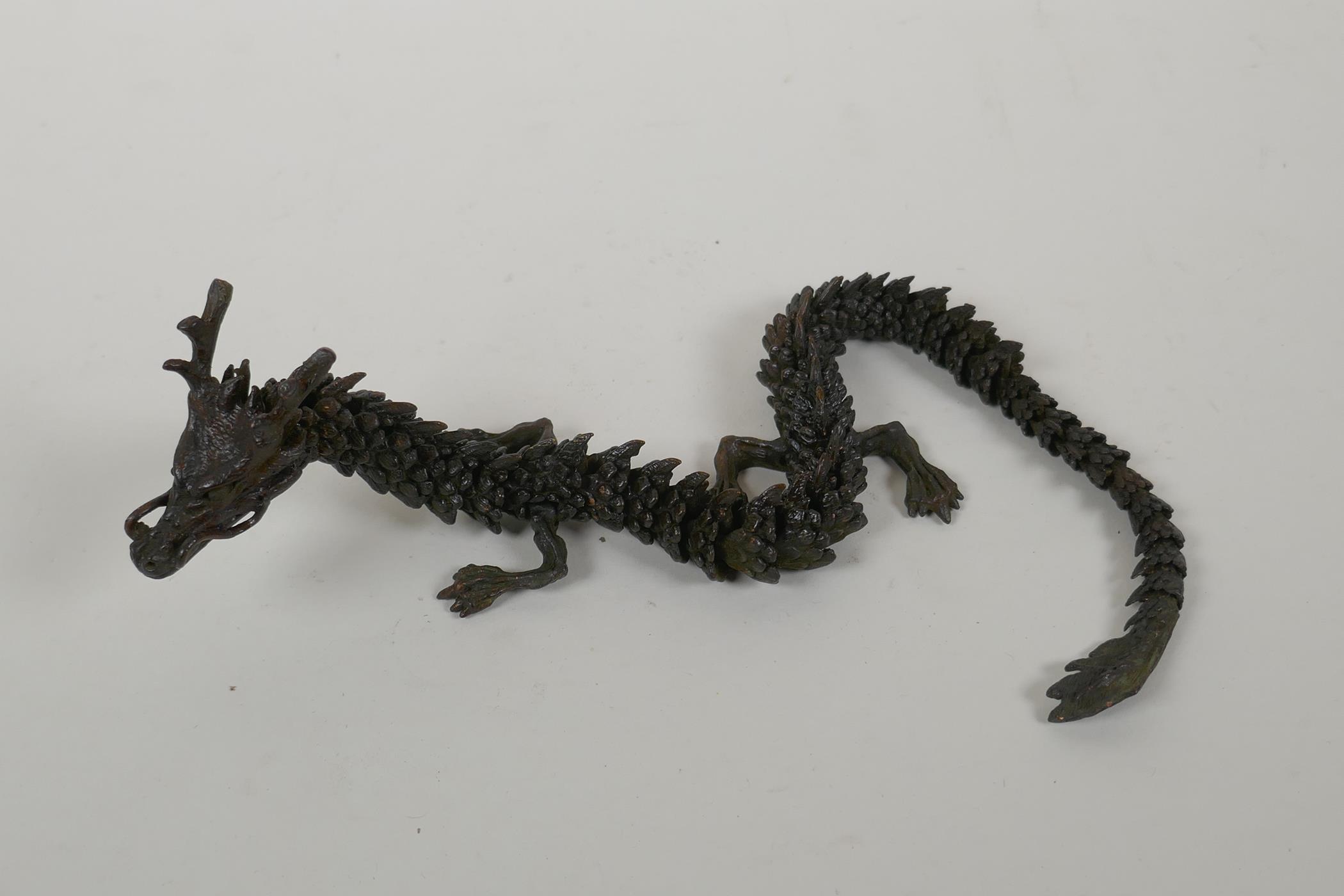 A Japanese Jizai style bronzed metal okimono dragon with articulated parts, 38cm long - Image 2 of 3