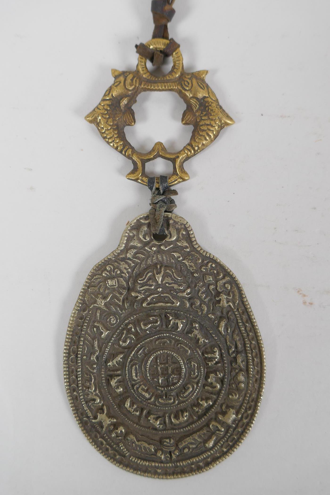 A Tibetan bronze and silvered metal calendar pendant, together with a bronze figure of a jolly - Image 2 of 3