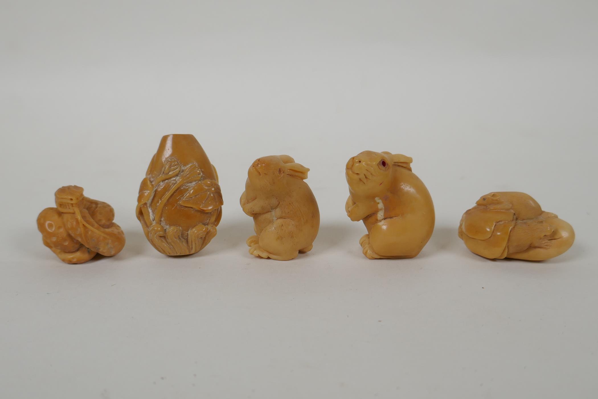 Five Japanese carved tagua nut netsuke in the form of rabbits, mice, lotus flowers and a snake,