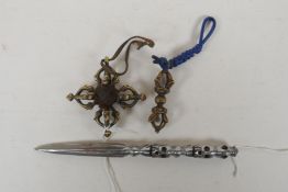 A small Tibetan bronze double vajra, a similar sized vajra pendant and a steel phurba with skull