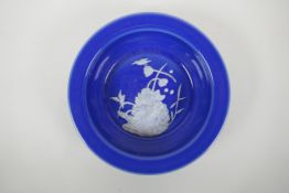 A Chinese blue ground porcelain bowl with pate sur pate decoration of birds and lotus flowers,