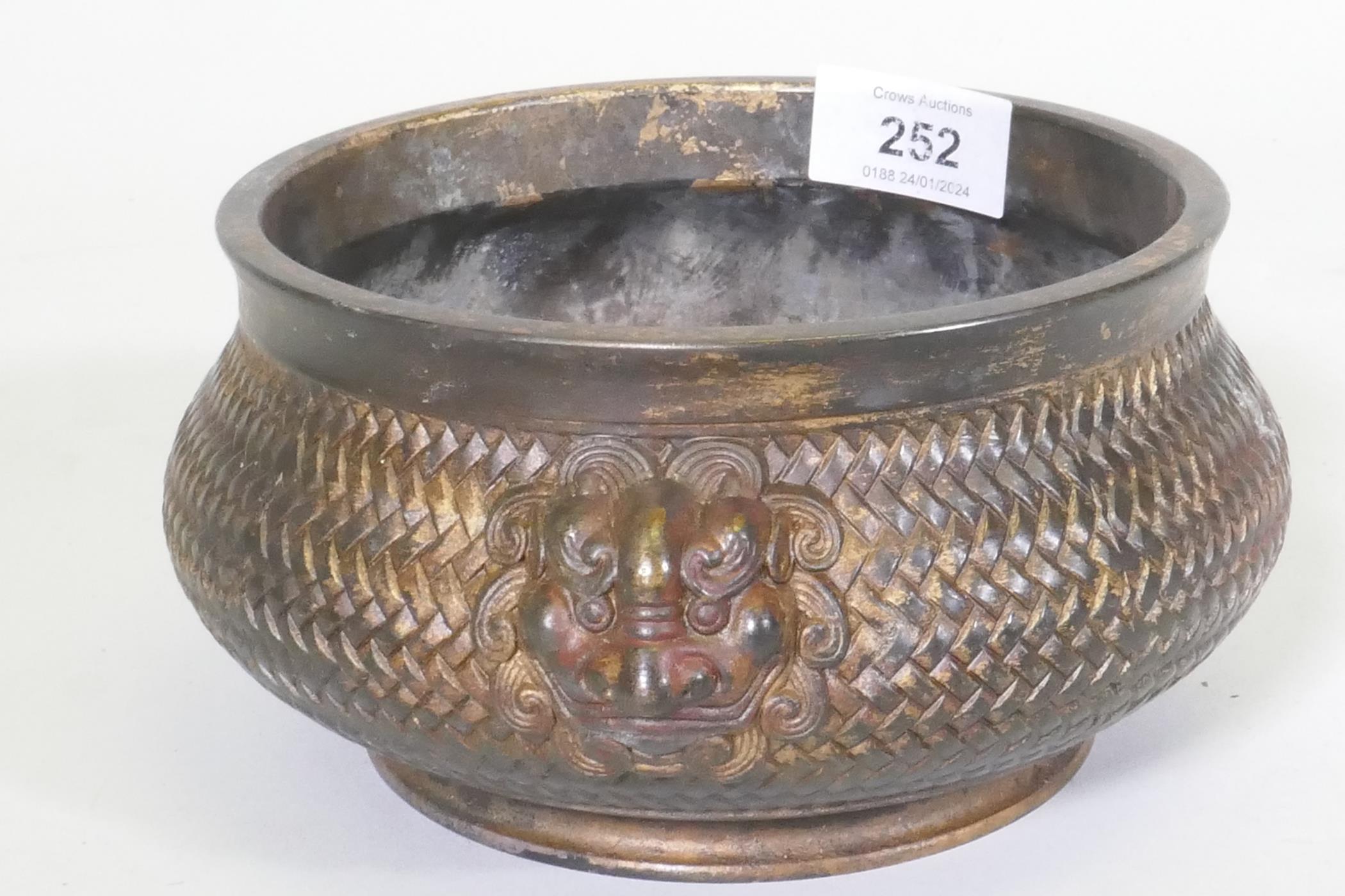 A Chinese bronze censer with mask decoration and woven basket style body, impressed seal mark to - Image 2 of 5