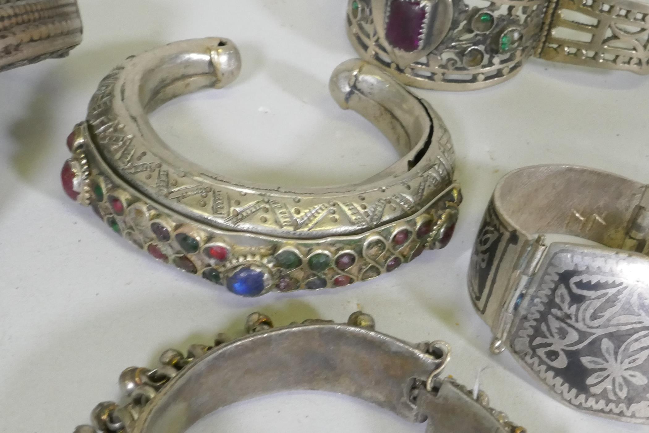 A collection of Afghan white metal bangles, set with paste stones, bidri style decoration, a Chinese - Image 5 of 6