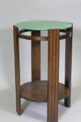 An Art Deco occasional table with marbled green glass top and undertier, 66cm high x 42cm diameter