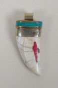 A Tibetan white metal mounted tooth pendant with enamel details, 7cm