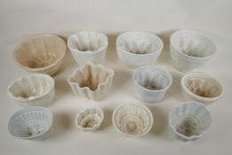 Twelve Victorian pottery jelly moulds of various sizes and shapes, largest 15cm high