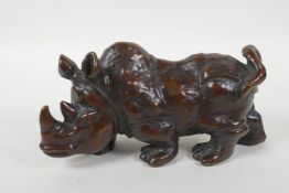 A filled bronze rhinoceros, 20cm long