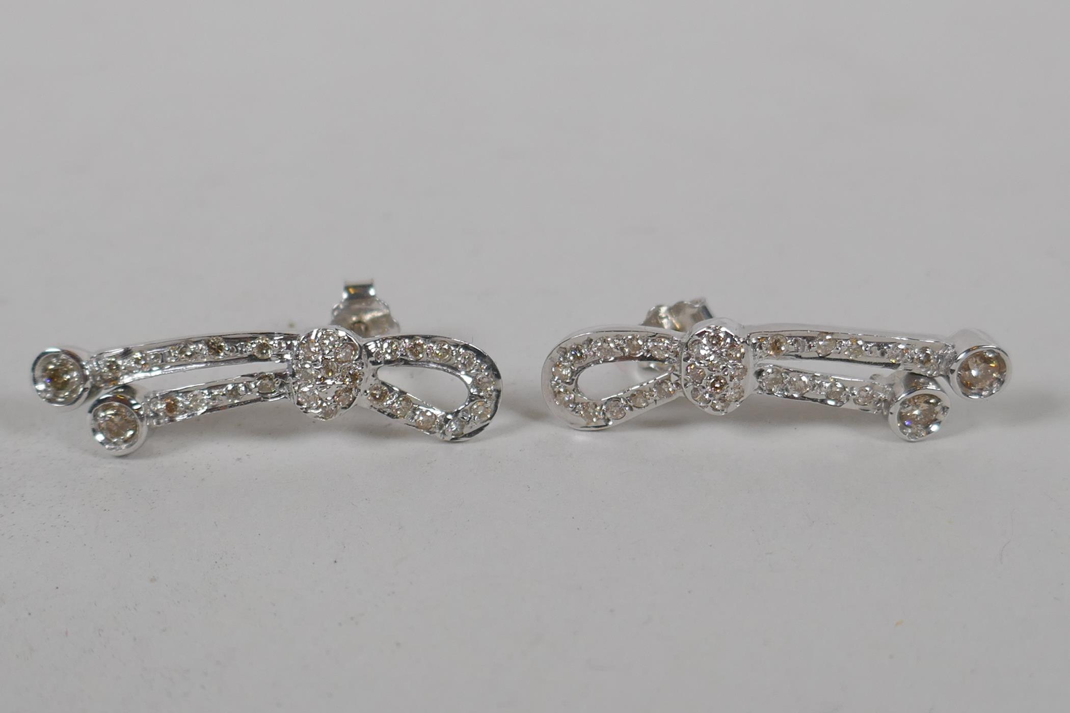 A pair of Iranian white gold and diamond set earrings, indistinctly marked, gold untested, 5.3g