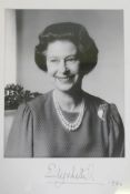 An autographed photo of Her Majesty Queen Elizabeth II, bromide print by John Lawrence, signed