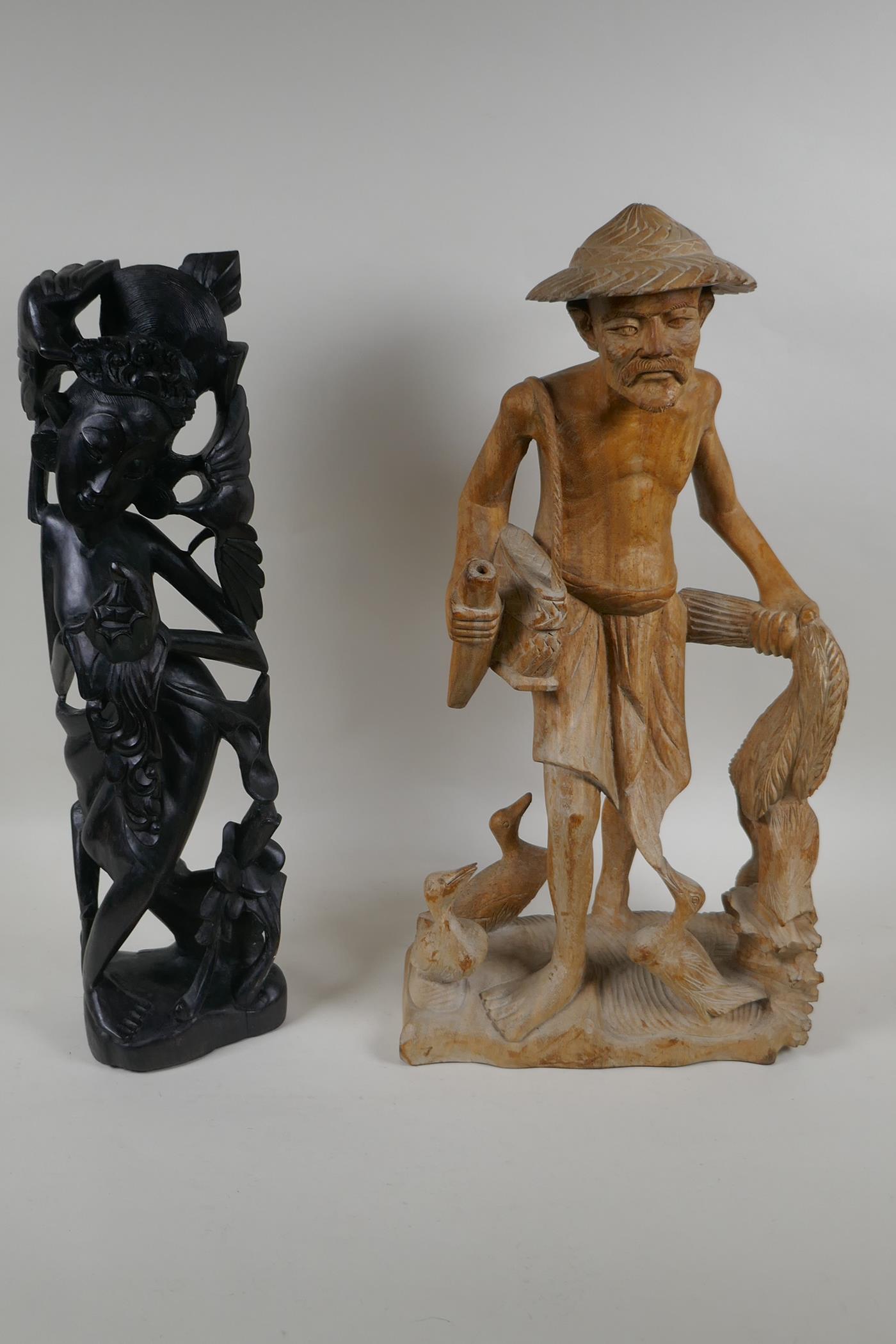 A Balinese carved hardwood figure of a dancer, and an oriental carved wood figure of a duck