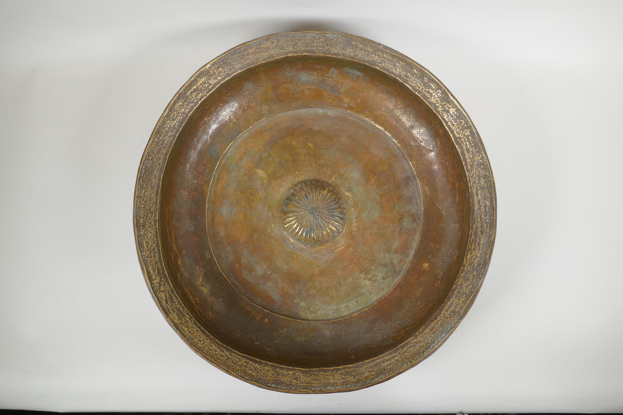 An antique Islamic gilt brass bowl with central boss and chased fish decoration, 46cm diameter - Image 2 of 5
