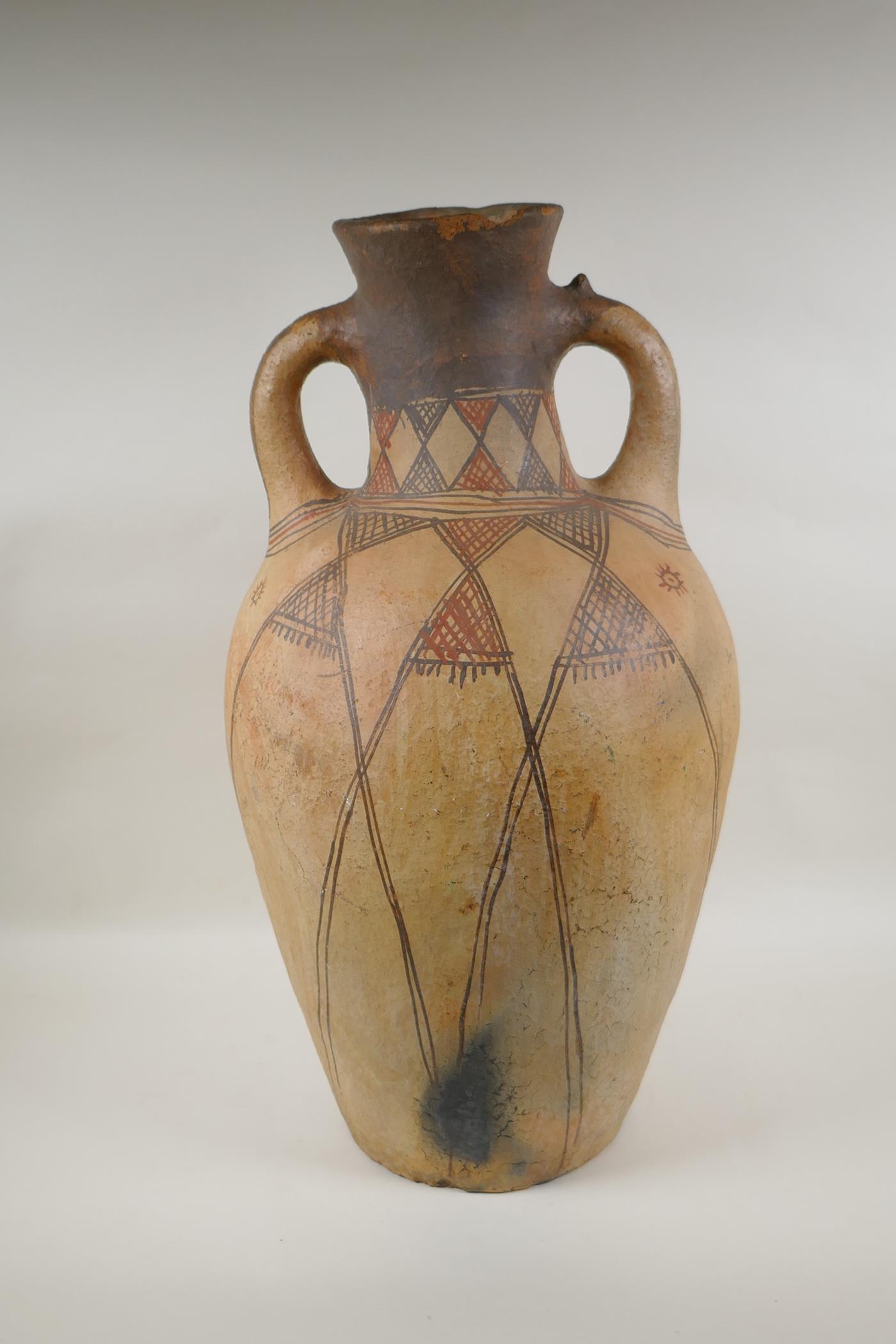 An antique North African terracotta amphora with two handles and hand painted design, AF, 63cm high - Image 3 of 6