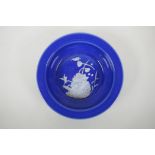 A Chinese blue ground porcelain bowl with pate sur pate decoration of birds and lotus flowers,