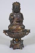 An oriental bronze censer in the form of a lotus with Buddivistic figure 24cm high