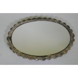 A Turkish silver framed mirror with repousse decoration and gilt highlights, stamped 900 Ohran