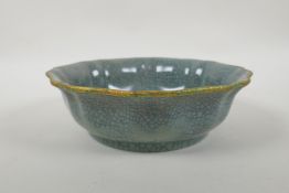 A Chinese celadon Ge ware bowl with frilled gilt rim and chased character inscription to bowl,