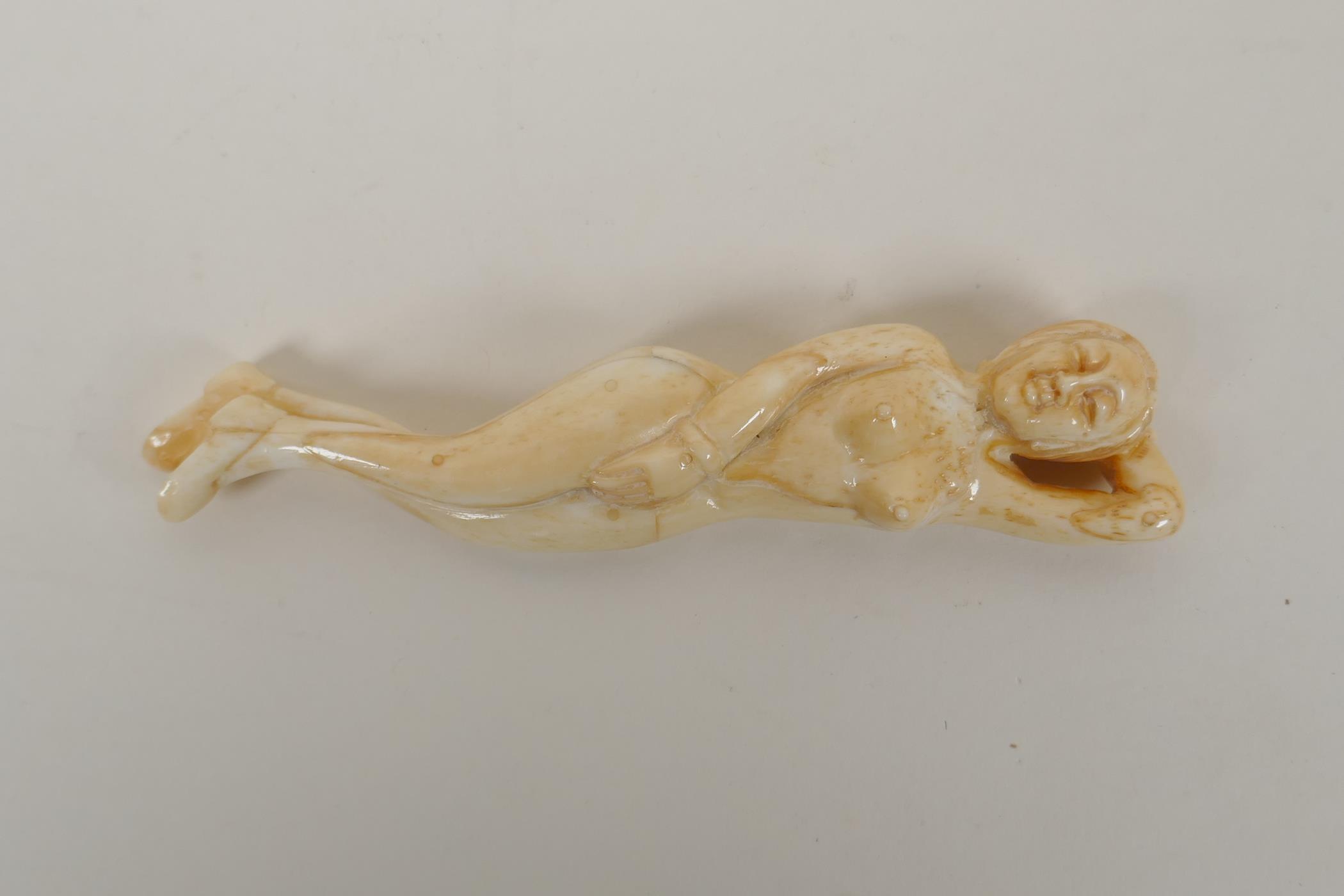 A carved bone figure of a nude, oriental woman, 13cm  long - Image 2 of 2