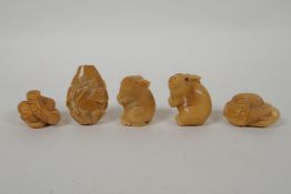Five Japanese carved tagua nut netsuke in the form of rabbits, mice, lotus flowers and a snake,