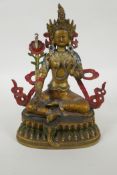 A Tibetan gilt and cold painted metal figure of the goddess Green Tara, 22cm high