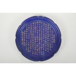 A Chinese deep blue ground charger with lobed rim, decorated with chased and gilt character