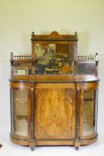 A Victorian inlaid figured walnut side cabinet, the mirrored back with galleried shelves, the base