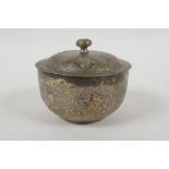 An Islamic white metal bowl, with all over script decoration, 8cm diameter, 98g